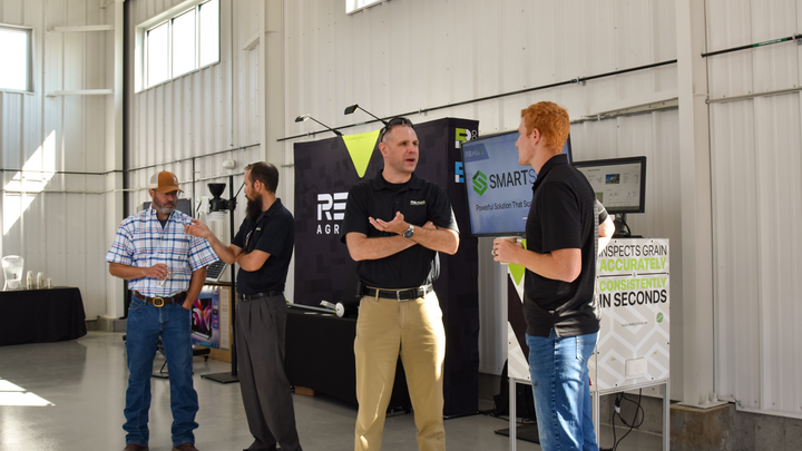 RealmFive CEO and Co-Founder Steve Tippery talks with Adam Leise who direction the Nebraska On-Farm Research Network during the NFarm Building ribbon cutting at ENREEC in August 2025